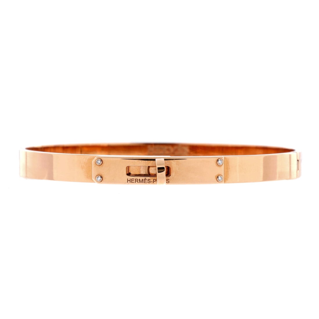 Hermes Kelly Bracelet 18K Rose Gold with 4 Diamonds (Small): The Hermes Kelly Bracelet in 18K rose gold renders the Kelly bag's signature Sangle closure - the lock-and-strap fastening originally borrowed from equestrian saddlery - as a fine-jewelry bracelet, wi
