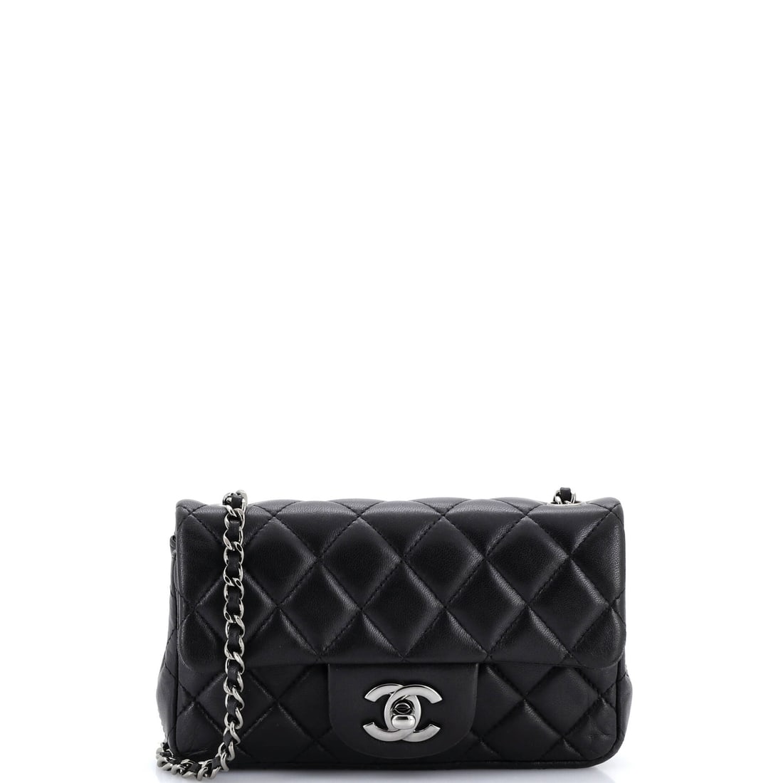 Chanel Classic Single Flap Bag Quilted Lambskin (Extra Mini): The Chanel Classic Single Flap Bag in Quilted Lambskin closes cleanly at the front, a small architectural moment that signals the model from across the room. Lambskin is the softer, more luminous of C
