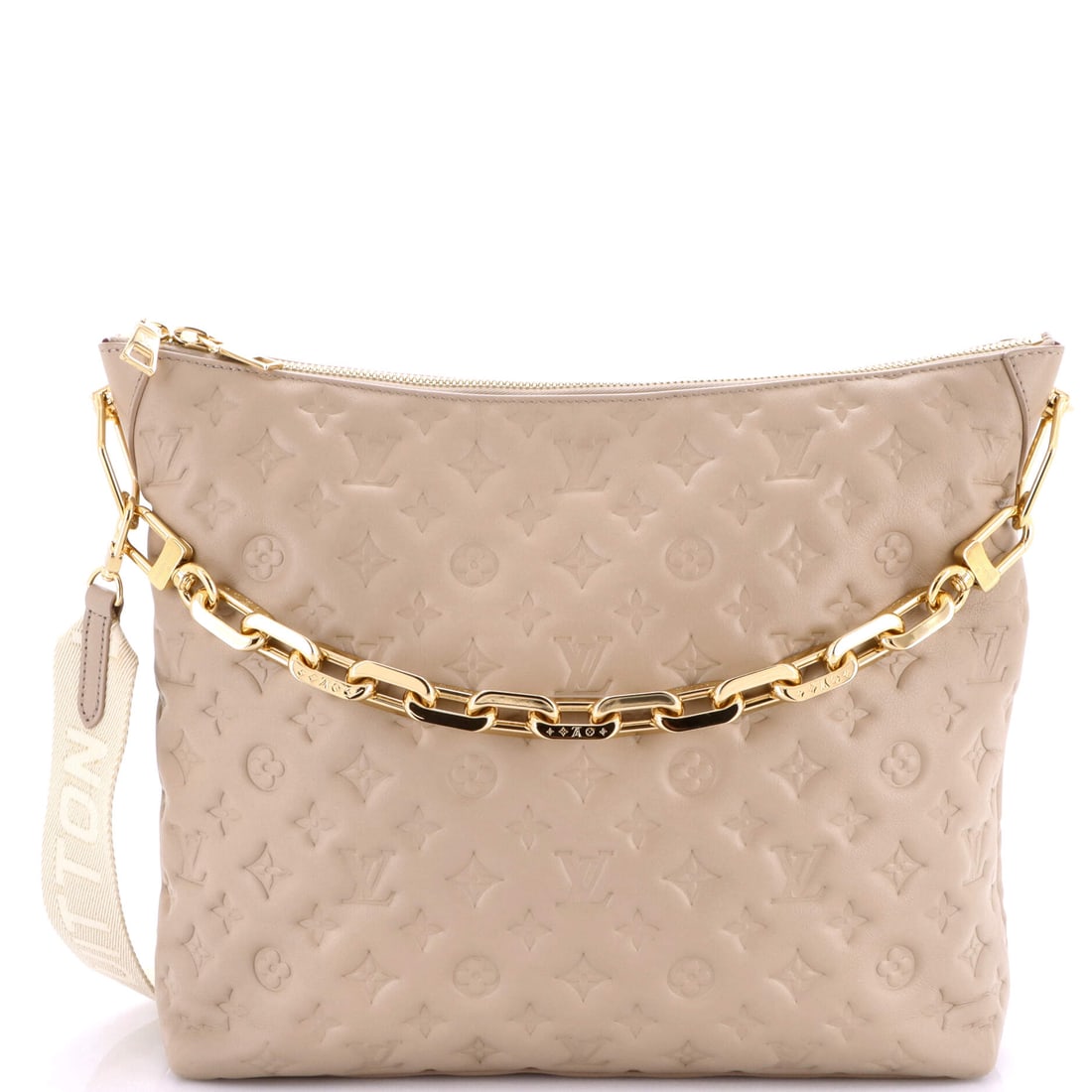 Louis Vuitton Coussin Hobo Monogram Embossed Lambskin: At full read, the Coussin is exactly what the line has always promised: the pillow-soft, lambskin-quilted silhouette Nicolas Ghesquiere introduced for Vuitton in 2021, with the chain-and-monogram-eyel