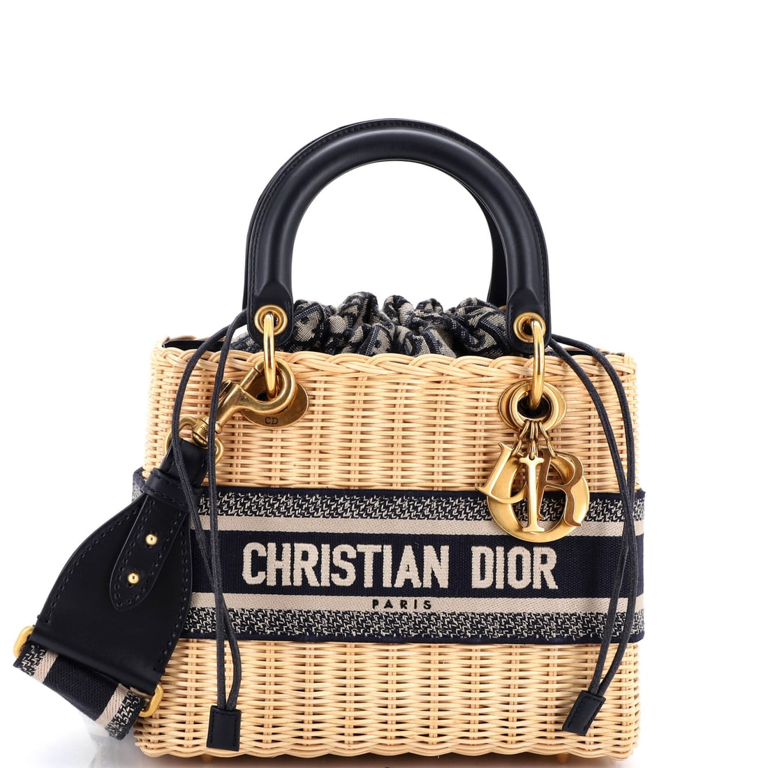 Christian Dior Lady Dior Bag Wicker and Oblique Canvas: Carried right, the Lady Dior reads as the house's working signature: the structured top-handle silhouette with its cannage quilting and the four DIOR charms that finish each handle. It is finished in 