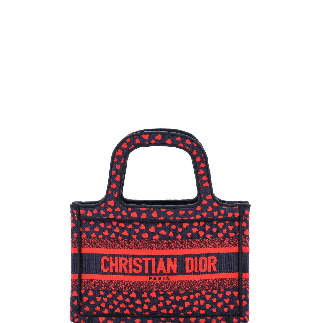 Christian Dior Book Tote I Love Paris Heart Embroidered Canvas: What anchors this Christian Dior Book Tote is precisely what anchors the line: the working silhouette the line is named for. The piece is finished in embroidered canvas (the Dior jacquard worked throu