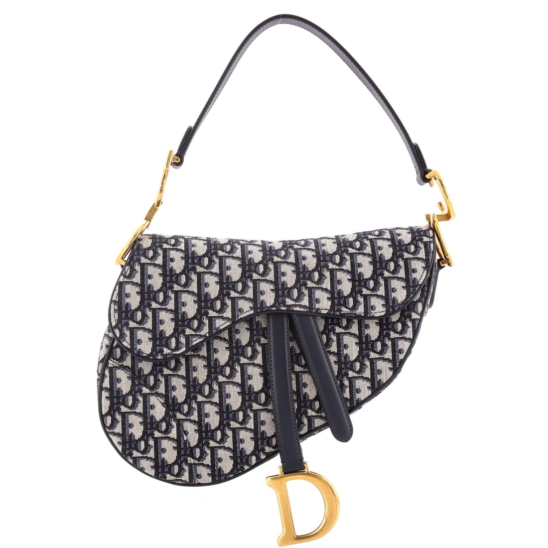 Christian Dior Saddle Handbag Oblique Canvas: Look closely at the Saddle and the architecture explains itself - the asymmetric, stirrup-clasp silhouette John Galliano drew up for Dior in 1999. The piece is finished in Oblique - Dior's diagonal-mo