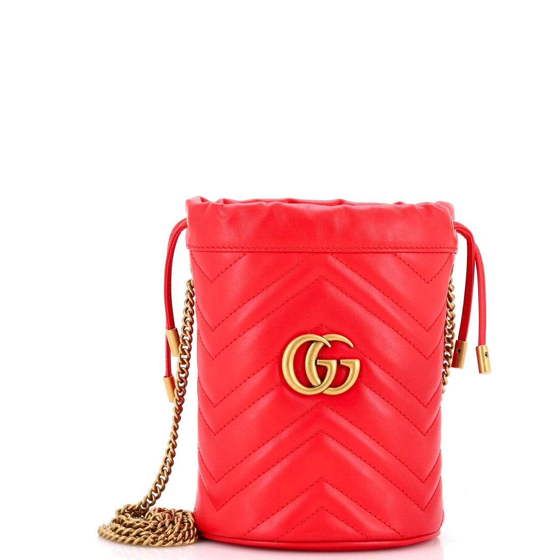 Gucci GG Marmont Bucket Bag Matelasse Leather: Open the Marmont once and the line announces itself: the quilted-leather flap silhouette finished with the antique-finish double-G clasp that names it. It is finished in matelasse leather (the chevron