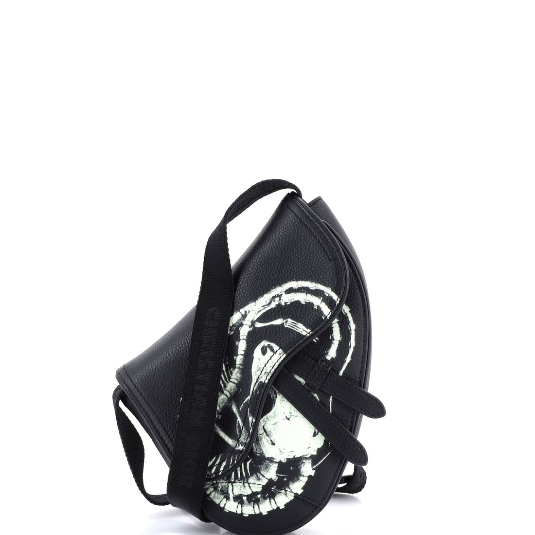 Christian Dior x Cactus Jack Saddle Crossbody Bag Printed Leather: Read this Saddle against its lineage and the design choices line up exactly: the asymmetric, stirrup-clasp silhouette John Galliano drew up for Dior in 1999. With a 5 by 8 by 2 inch format, the piece