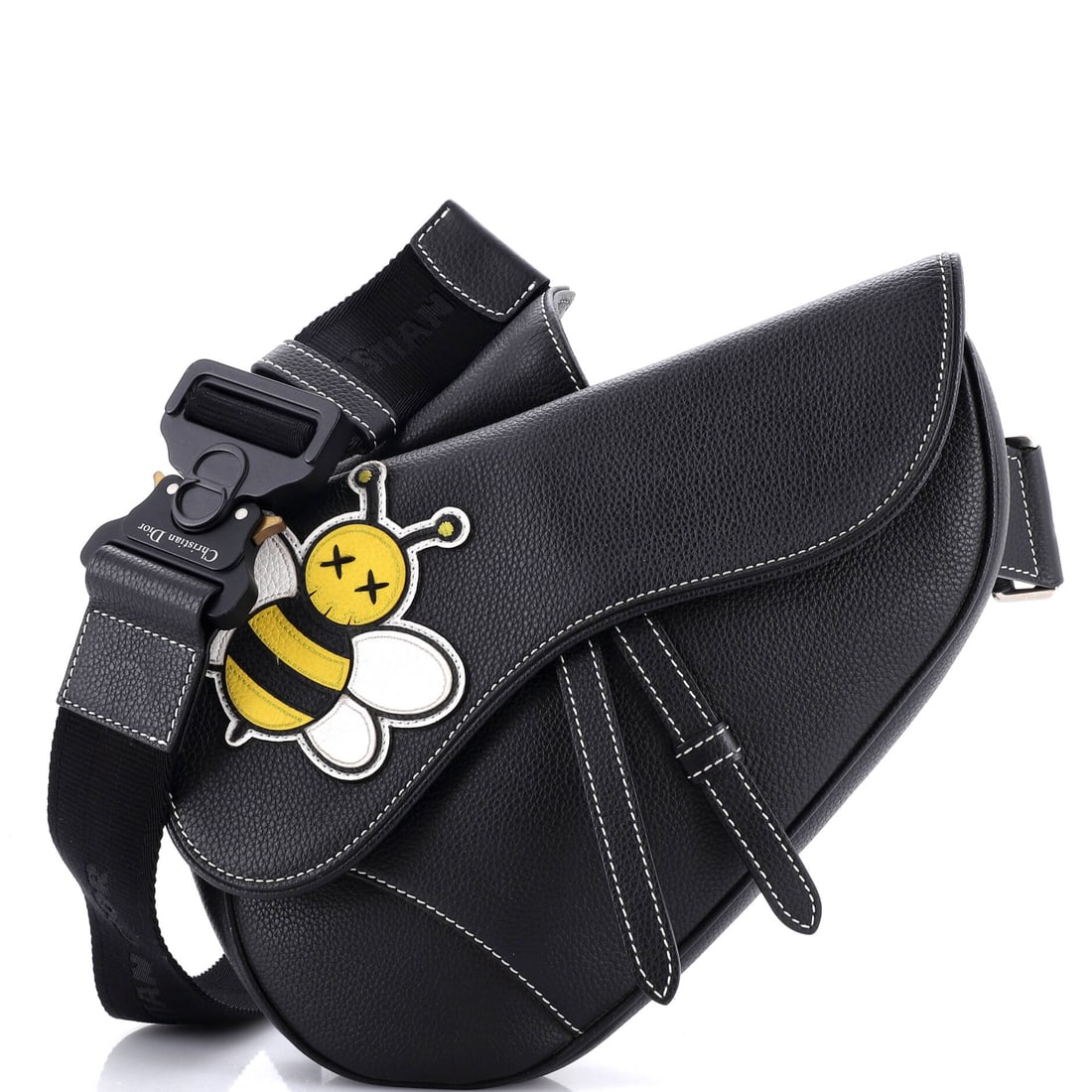 Christian Dior KAWS Saddle Crossbody Bag Leather with Applique: The reason the Saddle continues to anchor the Christian Dior catalogue is simple: the asymmetric, stirrup-clasp silhouette John Galliano drew up for Dior in 1999. Sized with a comfortable everyday 7 b