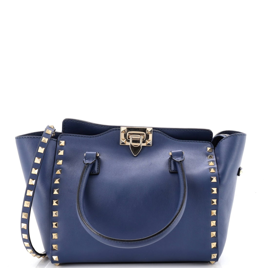 Valentino Garavani Rockstud Tote Rigid Leather Small: Within Valentino Garavani's catalog, the Rockstud Tote occupies the territory between everyday tote and editorial carry. Worked in Rigid Leather, the surface carries a measured, well-bred polish. The