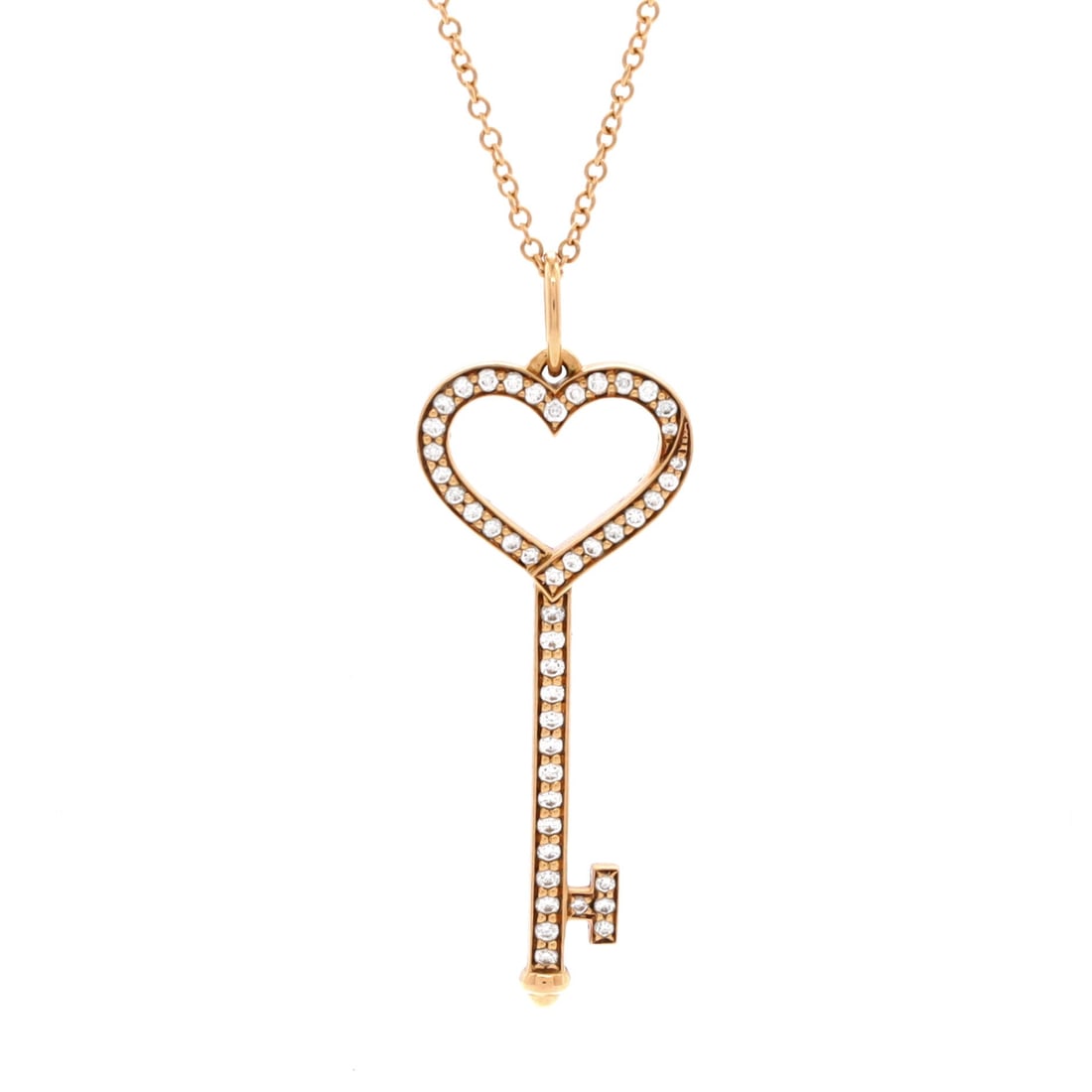 Tiffany & Co. Open Heart Key Pendant Necklace 18K Rose Gold with Pave Diamonds Small: Rendered in rose gold, the Tiffany & Co. Open Heart Key Pendant Necklace reads as both ornament and quiet emblem. Worked in 18K Rose Gold with Pave Diamonds. The drop sits exactly at the spot a though