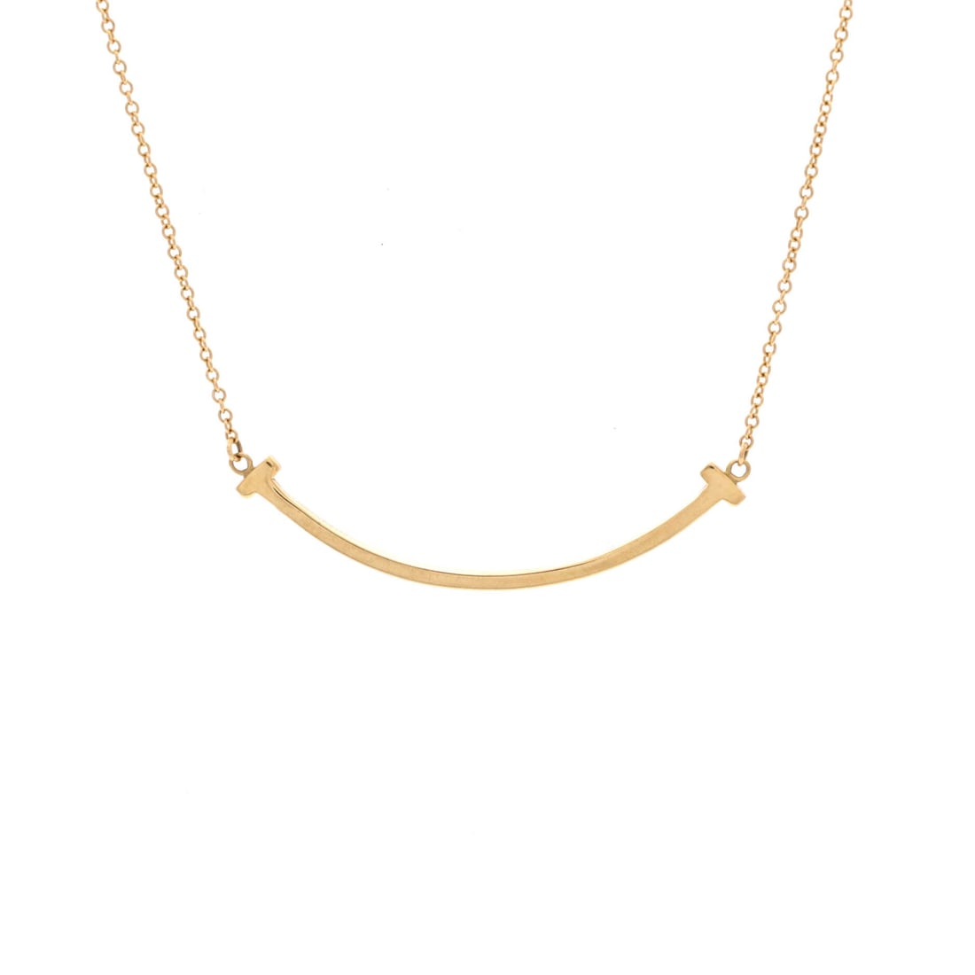 Tiffany & Co. T Smile Pendant Necklace 18K Yellow Gold Small: Presented in yellow gold, the Tiffany & Co. T Smile Pendant Necklace translates a house signature into a wearable line. Worked in 18K Yellow Gold. Scale-wise it lives in the sweet spot between everyda