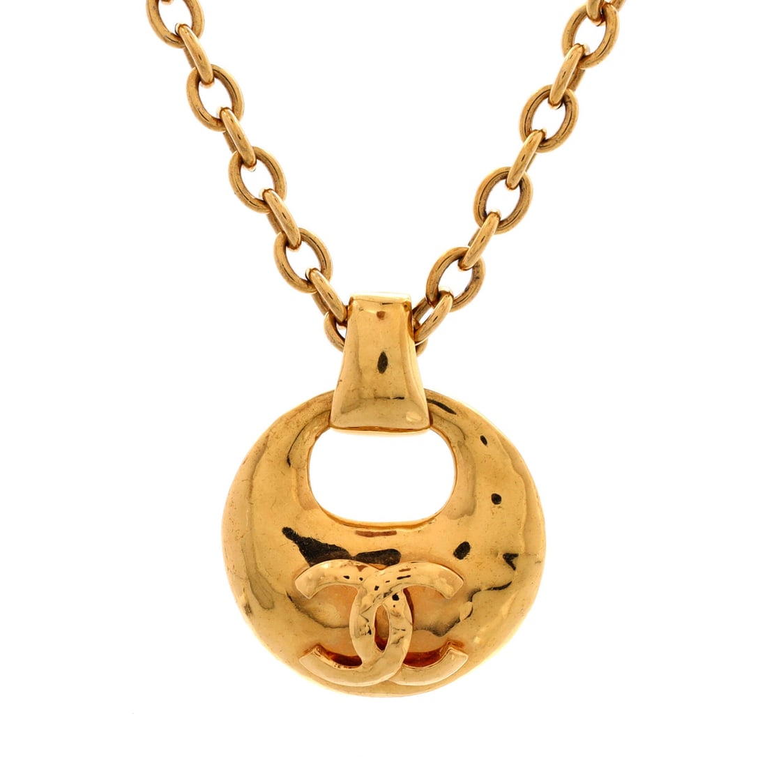 Chanel Vintage CC Round Cut-Out Pendant Necklace Metal: Set in polished gold, the Chanel Vintage CC Round Cut-Out Pendant Necklace sits with elegant intent against the collarbone. Worked in Metal. The drop sits exactly at the spot a thoughtful piece is