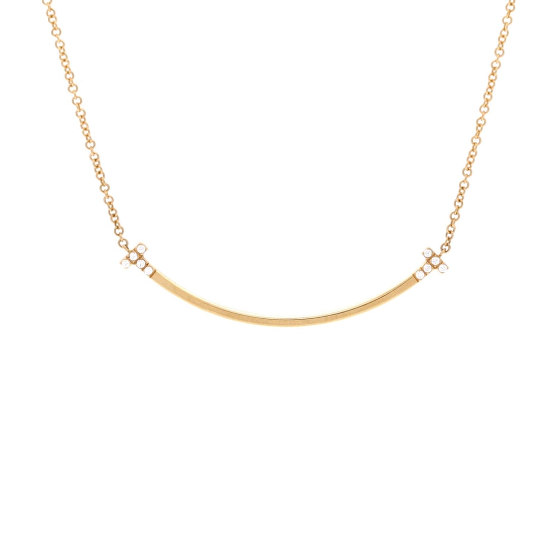 Tiffany & Co. T Smile Pendant Necklace 18K Yellow Gold with Diamonds Small: Anchored in yellow gold, the Tiffany & Co. T Smile Pendant Necklace sits exactly where a thoughtful piece is meant to land. Worked in 18K Yellow Gold with Diamonds. Its proportions slip cleanly under 