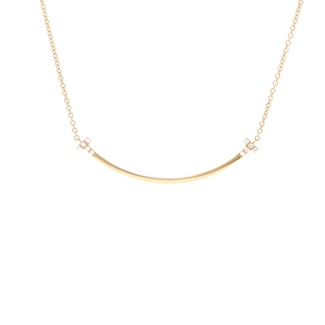Tiffany & Co. T Smile Pendant Necklace 18K Yellow Gold with Diamonds Small: Worked in yellow gold, the Tiffany & Co. T Smile Pendant Necklace threads its motif from clasp to charm with a single fluent gesture. Worked in 18K Yellow Gold with Diamonds. The drop sits exactly at 