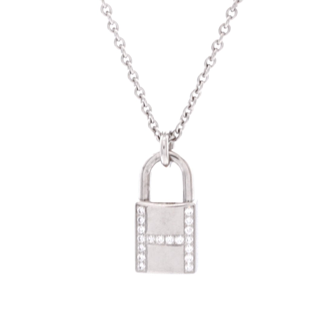 Hermes Amulettes Cadenas Pendant Necklace 18K White Gold with Diamonds: Crisply drawn, the Hermes Amulettes Cadenas Pendant Necklace translates a house signature into a wearable line. Worked in 18K White Gold with Diamonds. Its proportions slip cleanly under a collar yet 