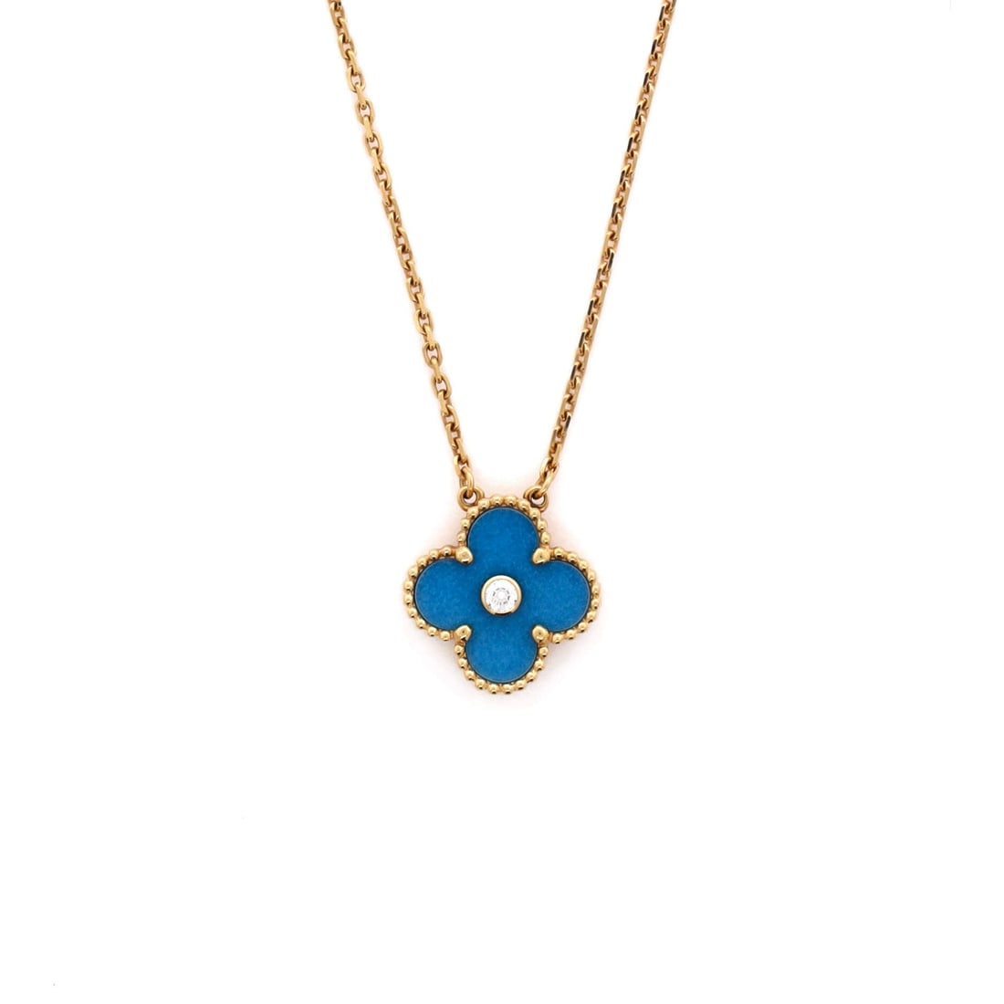 Van Cleef & Arpels Vintage Alhambra Pendant Necklace: Crisply drawn, the Van Cleef & Arpels Vintage Alhambra Pendant Necklace pulls focus to the collarbone with composed restraint. Worked in 18K Yellow Gold and Blue Sevres Porcelain with Diamond. Scale-w