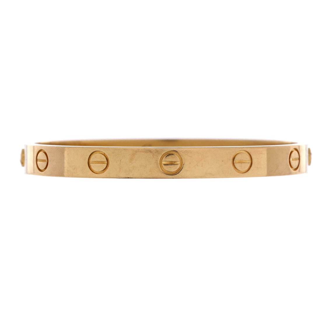 Cartier Love Bracelet 18K Yellow Gold: Cuffed with calm, the Cartier Love Bracelet sits as low-profile as it does deliberate. Worked in 18K Yellow Gold. The articulation traces the wrist closely, so it lays flat rather than rolling. Worn a