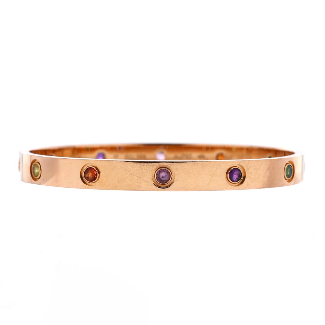 Cartier Love 10 Stone Bracelet 18K Rose Gold with Garnet, Amethyst and Sapphire: Hugging the wrist, the Cartier Love 10 Stone Bracelet holds its line with the disciplined geometry of a house signature. Worked in 18K Rose Gold with Garnet, Amethyst and Sapphire. Its band proportion