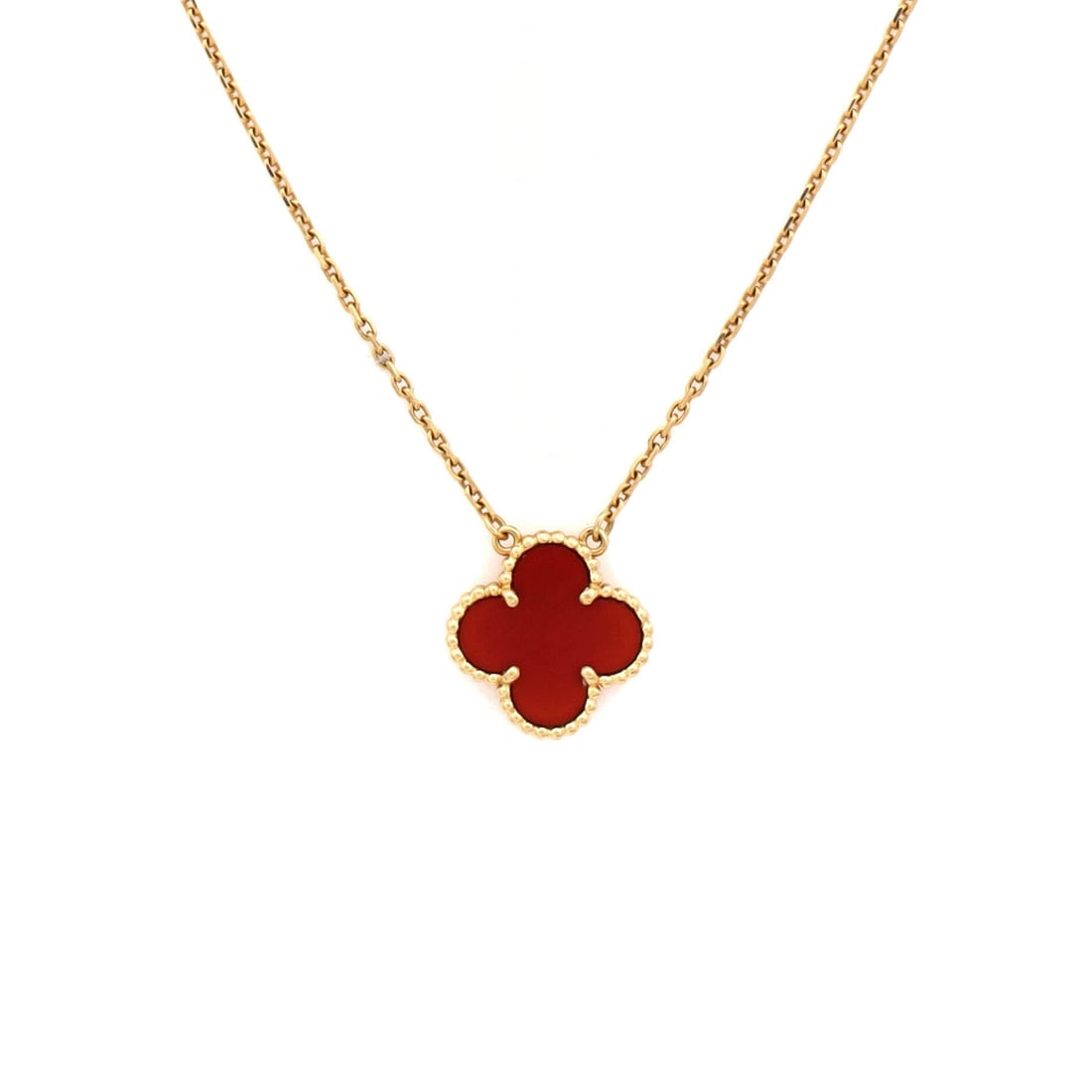 Van Cleef & Arpels Vintage Alhambra Pendant Necklace 18K Yellow Gold and Carnelian: Cast in yellow gold, the Van Cleef & Arpels Vintage Alhambra Pendant Necklace balances proportion with a piece-of-jewelry confidence. Worked in 18K Yellow Gold and Carnelian. Scale-wise it lives in th
