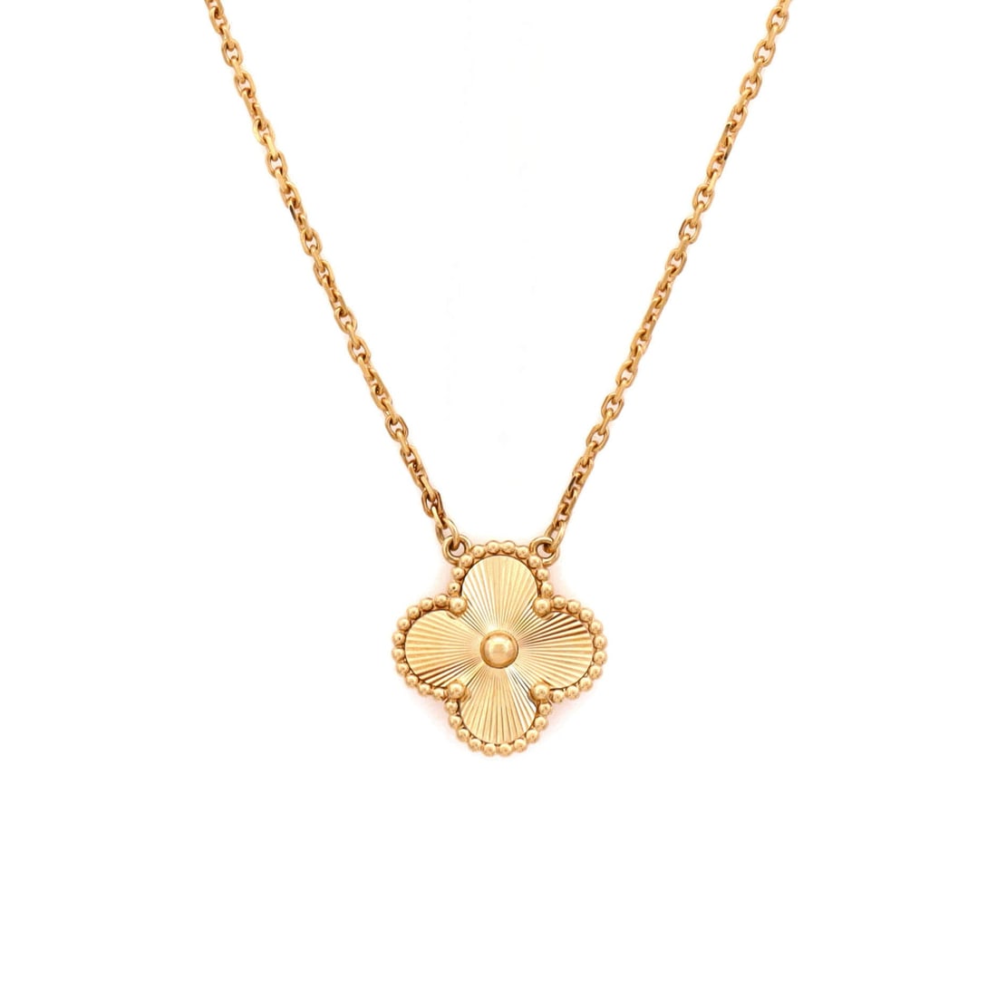 Van Cleef & Arpels Vintage Alhambra Pendant Necklace Guilloche 18K Yellow Gold: Layered to wear, the Van Cleef & Arpels Vintage Alhambra Pendant Necklace keeps its silhouette spare and its presence assured. Worked in Guilloche 18K Yellow Gold. Its proportions slip cleanly under a