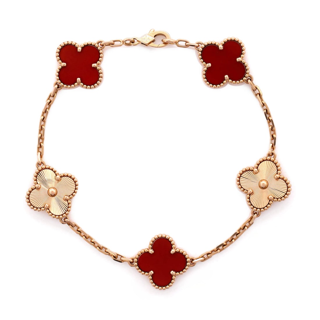 Van Cleef & Arpels Vintage Alhambra 5 Motifs Bracelet Guilloche 18K Rose Gold and Carnelian: Worked in rose gold, the Van Cleef & Arpels Vintage Alhambra 5 Motifs Bracelet sits as low-profile as it does deliberate. Worked in Guilloche 18K Rose Gold and Carnelian. The articulation traces the w
