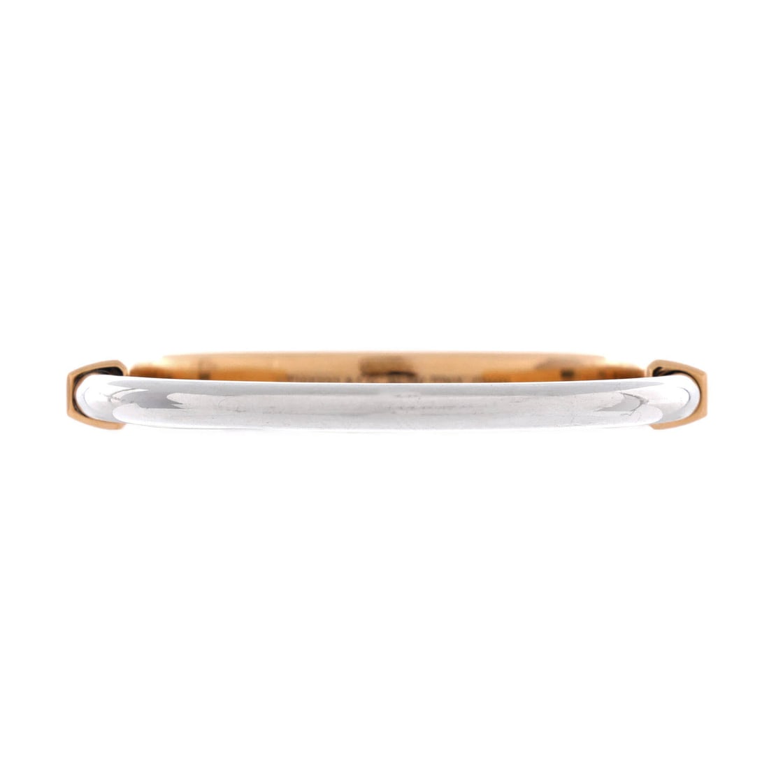 Tiffany & Co. Lock Bangle Bracelet 18K Rose Gold and 18K White Gold: Crisply joined, the Tiffany & Co. Lock Bangle Bracelet layers neatly under a sleeve and still reads from across the room. Worked in 18K Rose Gold and 18K White Gold. Its band proportion reads as subst