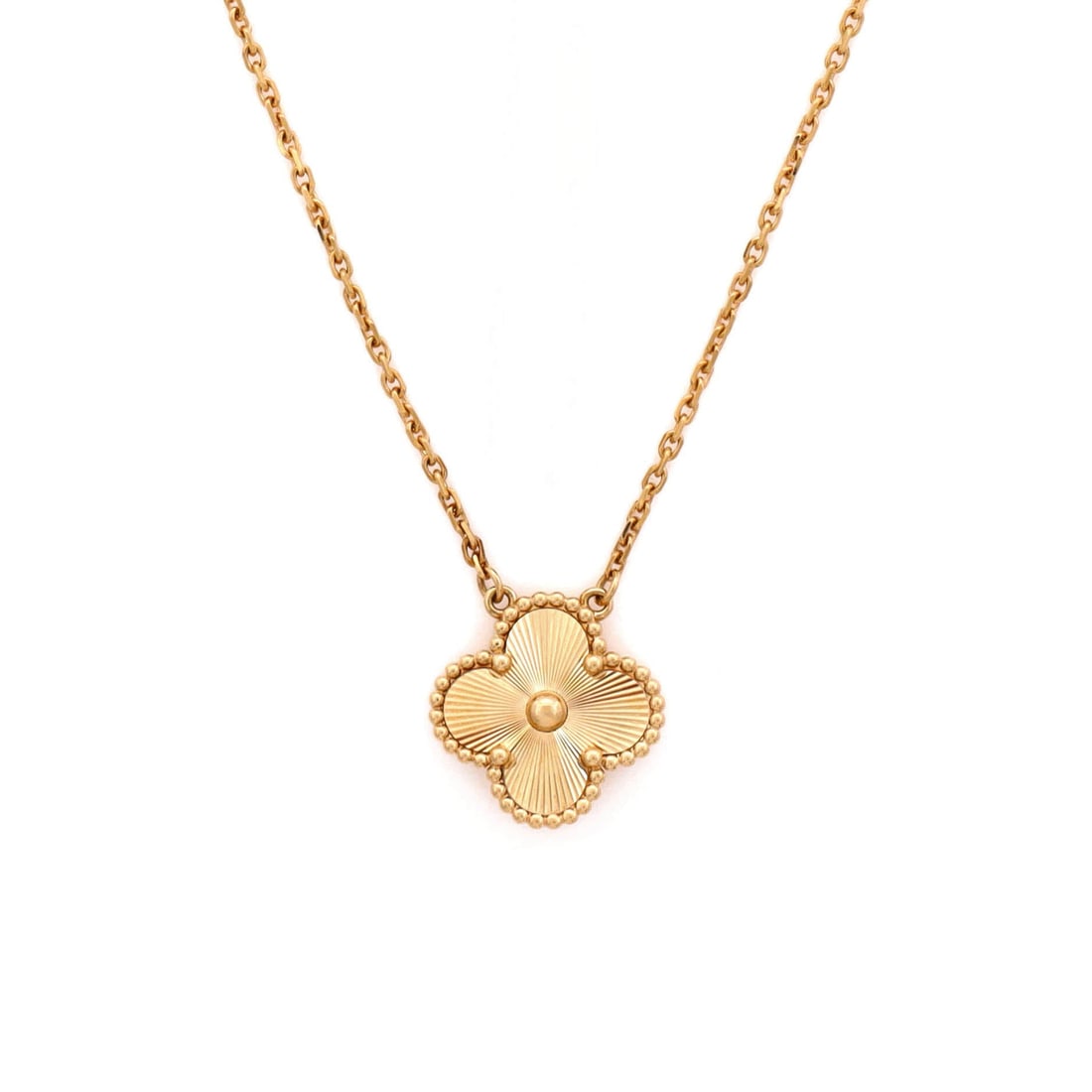 Van Cleef & Arpels Vintage Alhambra Pendant Necklace Guilloche 18K Yellow Gold: Rendered in yellow gold, the Van Cleef & Arpels Vintage Alhambra Pendant Necklace carries its motif with quiet authority. Worked in Guilloche 18K Yellow Gold. Its proportions slip cleanly under a coll