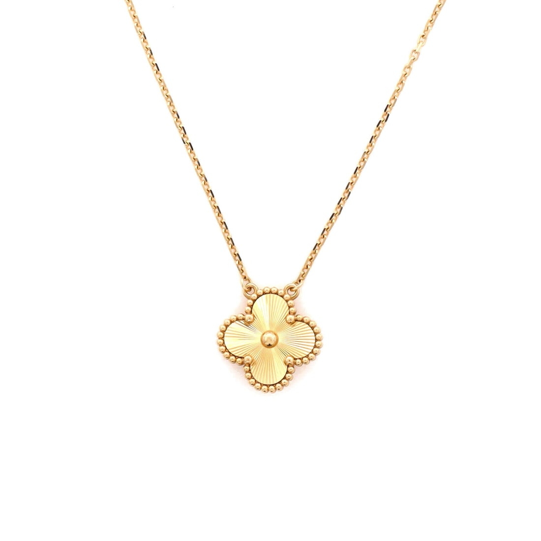 Van Cleef & Arpels Vintage Alhambra Pendant Necklace Guilloche 18K Yellow Gold: Presented in yellow gold, the Van Cleef & Arpels Vintage Alhambra Pendant Necklace threads its motif from clasp to charm with a single fluent gesture. Worked in Guilloche 18K Yellow Gold. Scale-wise i