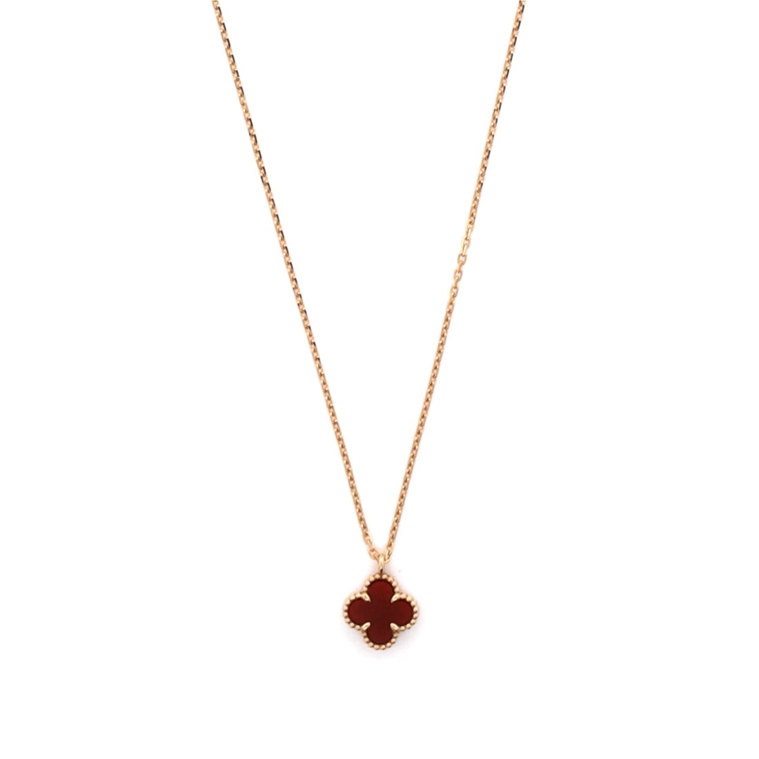 Van Cleef & Arpels Sweet Alhambra Pendant Necklace 18K Rose Gold and Carnelian: Crisply drawn, the Van Cleef & Arpels Sweet Alhambra Pendant Necklace sits with elegant intent against the collarbone. Worked in 18K Rose Gold and Carnelian. The chain length reads as classic mid-coll