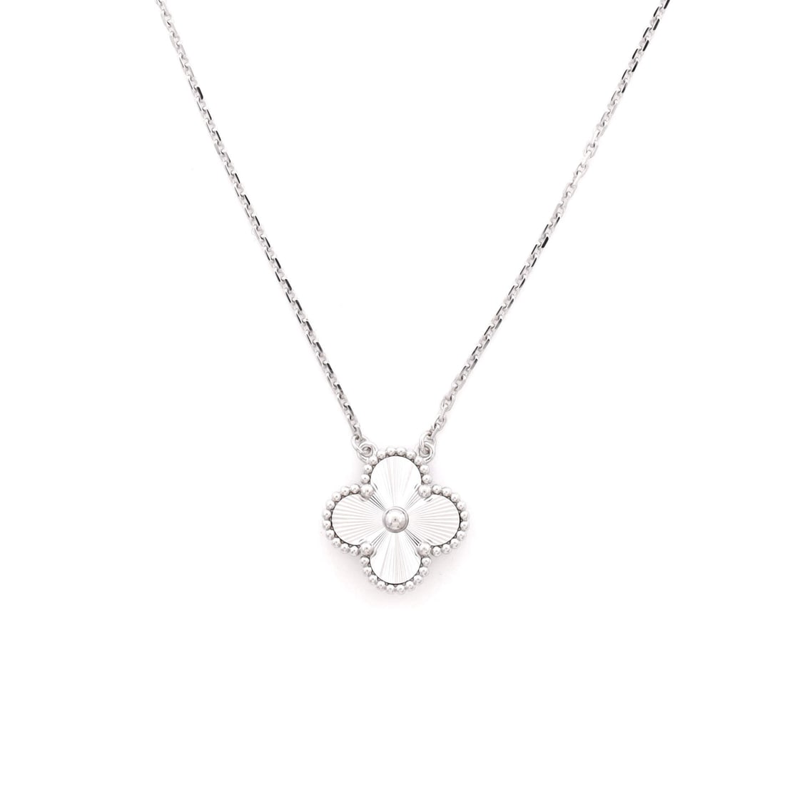 Van Cleef & Arpels Vintage Alhambra Pendant Necklace Guilloche 18K White Gold: Crisply drawn, the Van Cleef & Arpels Vintage Alhambra Pendant Necklace positions its centerpiece exactly where the eye lands first. Worked in Guilloche 18K White Gold. The drop sits exactly at the sp