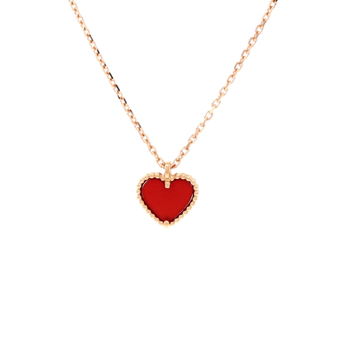 Van Cleef & Arpels Sweet Alhambra Heart Pendant Necklace 18K Rose Gold and Carnelian: Cast in rose gold, the Van Cleef & Arpels Sweet Alhambra Heart Pendant Necklace positions its centerpiece exactly where the eye lands first. Worked in 18K Rose Gold and Carnelian. The chain length rea