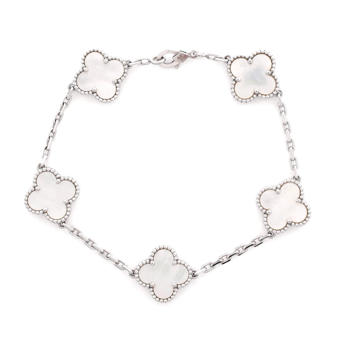 Van Cleef & Arpels Vintage Alhambra 5 Motifs Bracelet 18K White Gold and Mother of Pearl: Wrought in white gold, the Van Cleef & Arpels Vintage Alhambra 5 Motifs Bracelet rests with a confident architectural rhythm. Worked in 18K White Gold and Mother of Pearl. Its band proportion reads as