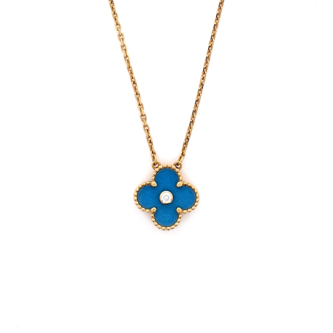 Van Cleef & Arpels Vintage Alhambra Pendant Necklace: Rendered in yellow gold, the Van Cleef & Arpels Vintage Alhambra Pendant Necklace carries its motif with quiet authority. Worked in 18K Yellow Gold and Blue Sevres Porcelain with Diamond. Its proporti