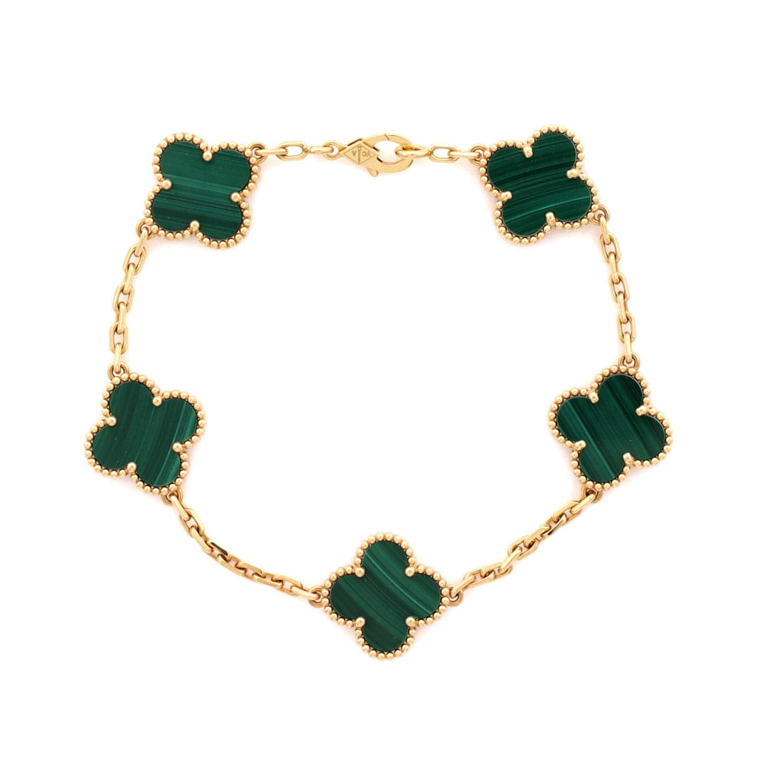 Van Cleef & Arpels Vintage Alhambra 5 Motifs Bracelet 18K Yellow Gold and Malachite: Worked in yellow gold, the Van Cleef & Arpels Vintage Alhambra 5 Motifs Bracelet sits as low-profile as it does deliberate. Worked in 18K Yellow Gold and Malachite. The articulation traces the wrist c