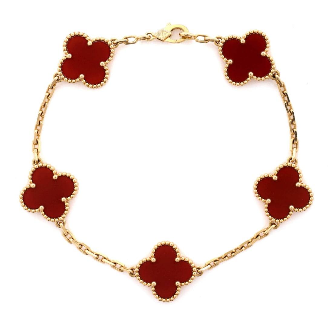 Van Cleef & Arpels Vintage Alhambra 5 Motifs Bracelet 18K Yellow Gold and Carnelian: Worked in yellow gold, the Van Cleef & Arpels Vintage Alhambra 5 Motifs Bracelet balances visual weight against an easy, everyday fit. Worked in 18K Yellow Gold and Carnelian. The articulation traces 