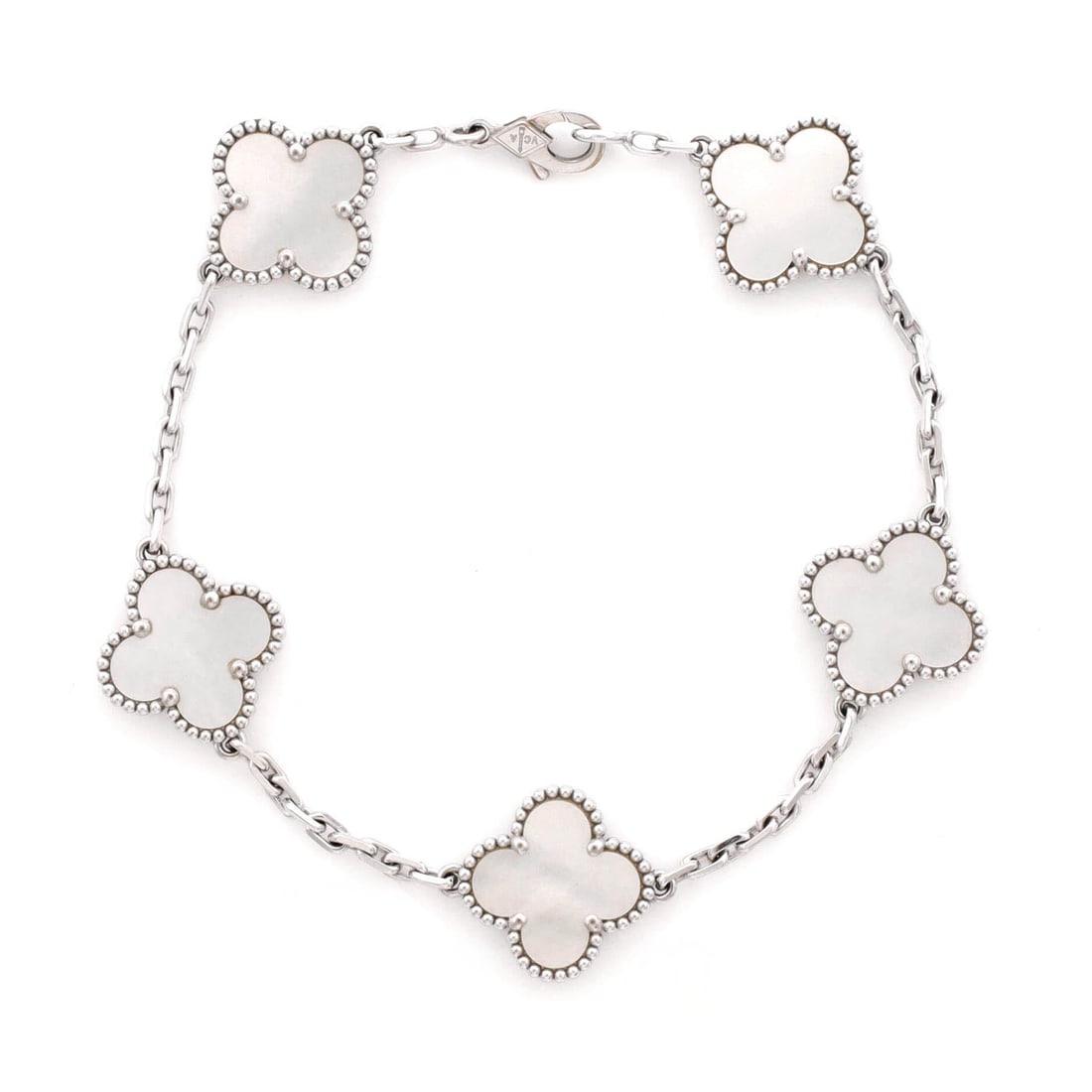 Van Cleef & Arpels Vintage Alhambra 5 Motifs Bracelet 18K White Gold and Mother of Pearl: Drawn in white gold, the Van Cleef & Arpels Vintage Alhambra 5 Motifs Bracelet layers neatly under a sleeve and still reads from across the room. Worked in 18K White Gold and Mother of Pearl. Its band