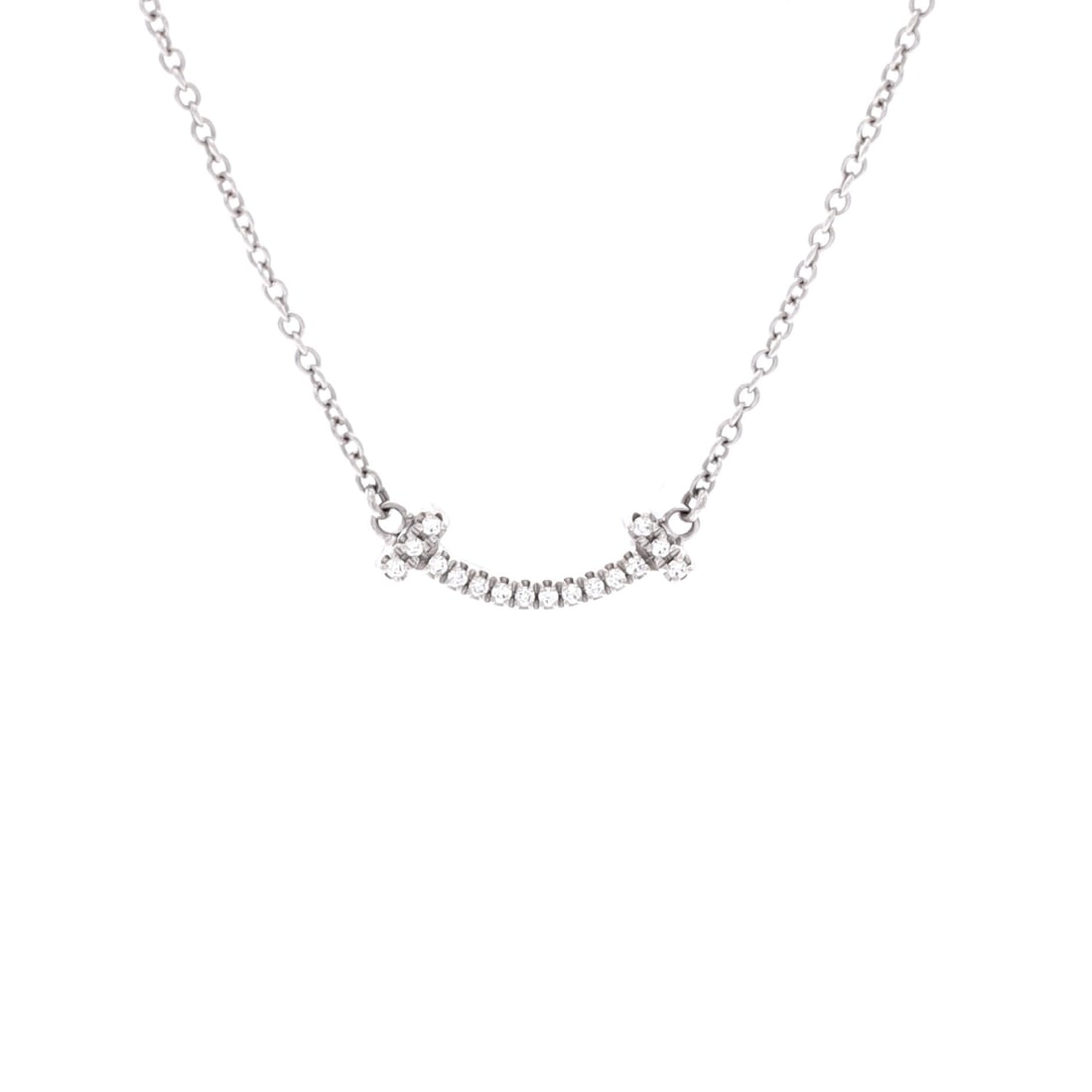 Tiffany & Co. T Smile Pendant Necklace 18K White Gold with Diamonds Mini: Anchored in white gold, the Tiffany & Co. T Smile Pendant Necklace sits exactly where a thoughtful piece is meant to land. Worked in 18K White Gold with Diamonds. Its proportions slip cleanly under a 