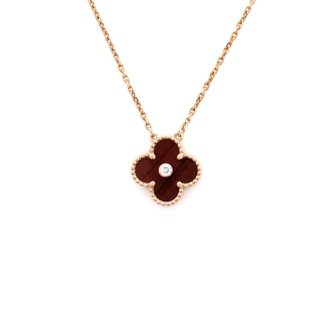 Van Cleef & Arpels Vintage Alhambra Pendant Necklace 18K Rose Gold and Bull's Eye with Diamond: Rendered in rose gold, the Van Cleef & Arpels Vintage Alhambra Pendant Necklace sits exactly where a thoughtful piece is meant to land. Worked in 18K Rose Gold and Bull's Eye with Diamond. The chain l