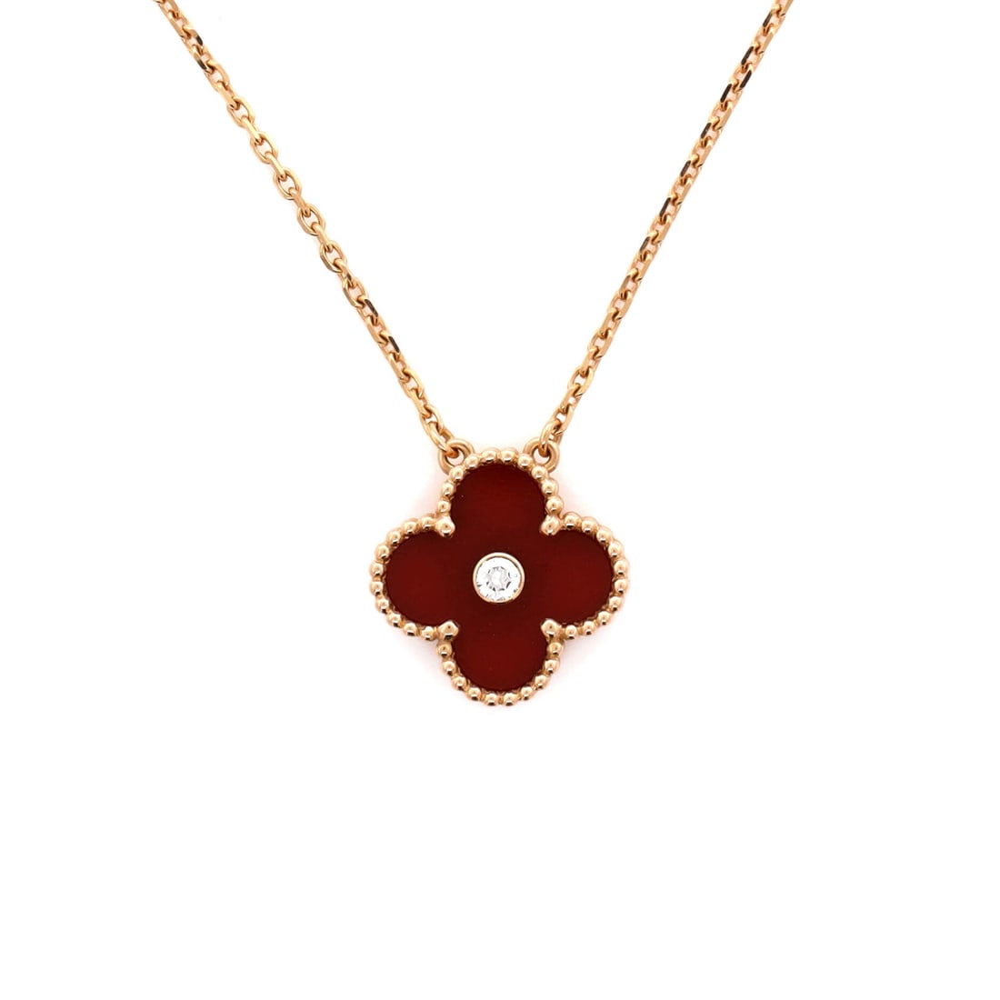 Van Cleef & Arpels Vintage Alhambra Pendant Necklace 18K Rose Gold and Carnelian with Diamond: Built for the collarbone, the Van Cleef & Arpels Vintage Alhambra Pendant Necklace threads its motif from clasp to charm with a single fluent gesture. Worked in 18K Rose Gold and Carnelian with Diamon