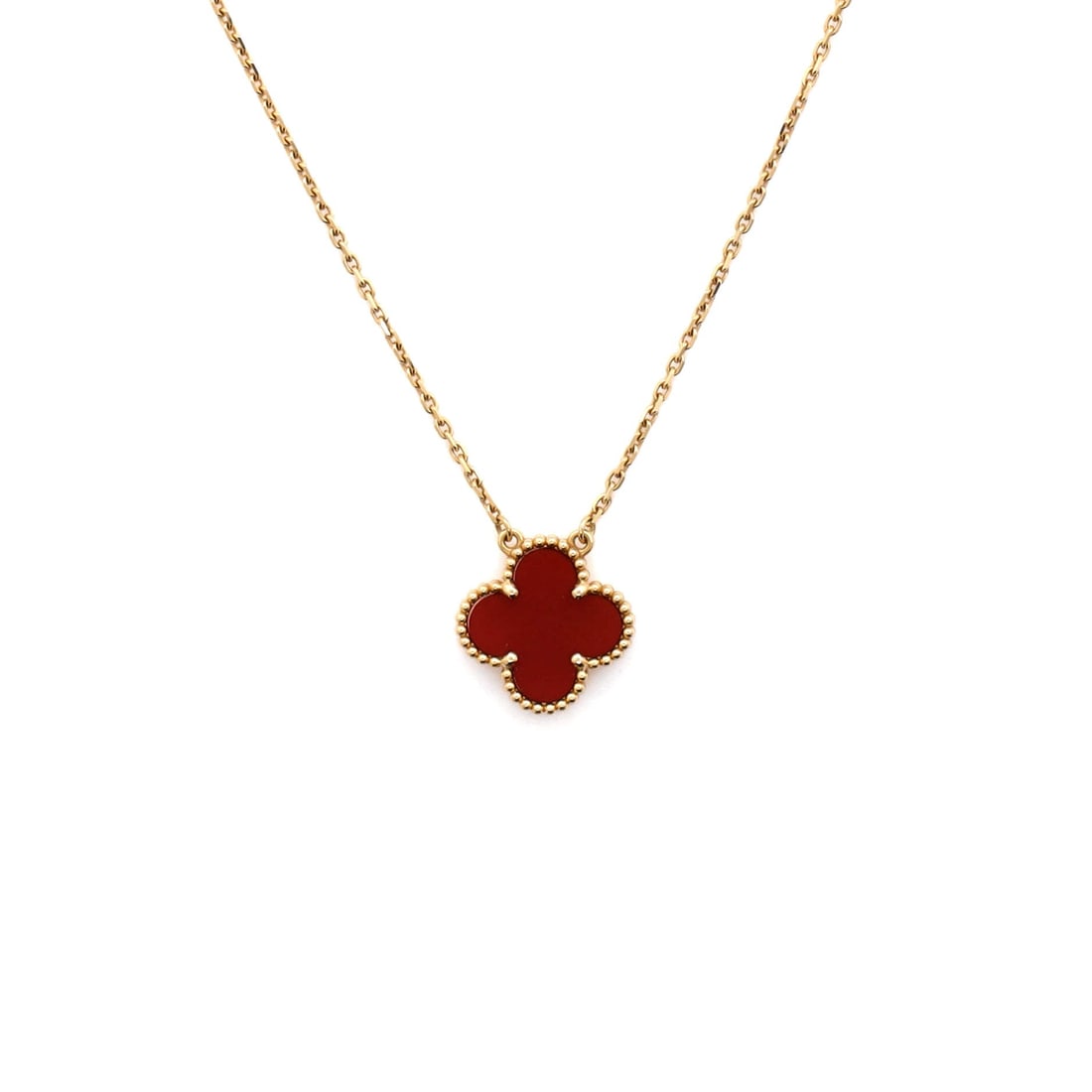 Van Cleef & Arpels Vintage Alhambra Pendant Necklace 18K Yellow Gold and Carnelian: Threaded in yellow gold, the Van Cleef & Arpels Vintage Alhambra Pendant Necklace reads as both ornament and quiet emblem. Worked in 18K Yellow Gold and Carnelian. Its proportions slip cleanly under a