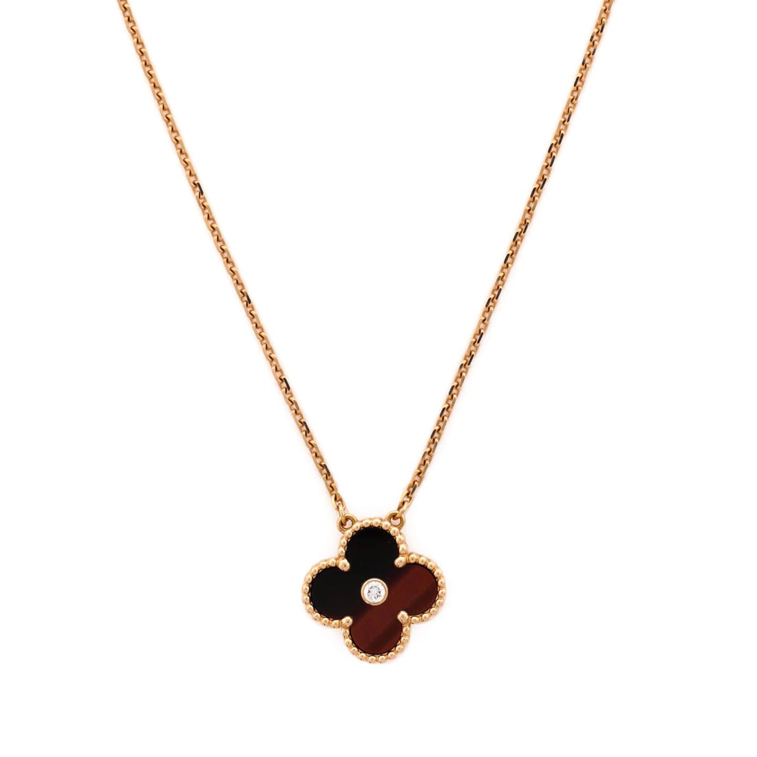 Van Cleef & Arpels Vintage Alhambra Pendant Necklace 18K Rose Gold and Bull's Eye with Diamond: Presented in rose gold, the Van Cleef & Arpels Vintage Alhambra Pendant Necklace threads its motif from clasp to charm with a single fluent gesture. Worked in 18K Rose Gold and Bull's Eye with Diamond