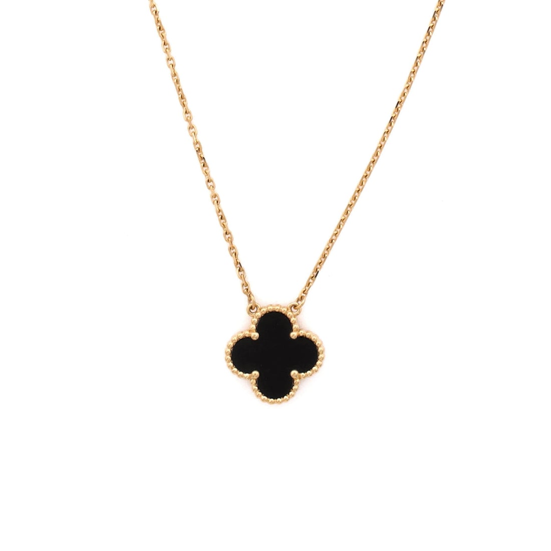 Van Cleef & Arpels Vintage Alhambra Pendant Necklace 18K Yellow Gold and Onyx: Layered to wear, the Van Cleef & Arpels Vintage Alhambra Pendant Necklace keeps its silhouette spare and its presence assured. Worked in 18K Yellow Gold and Onyx. Its proportions slip cleanly under a 