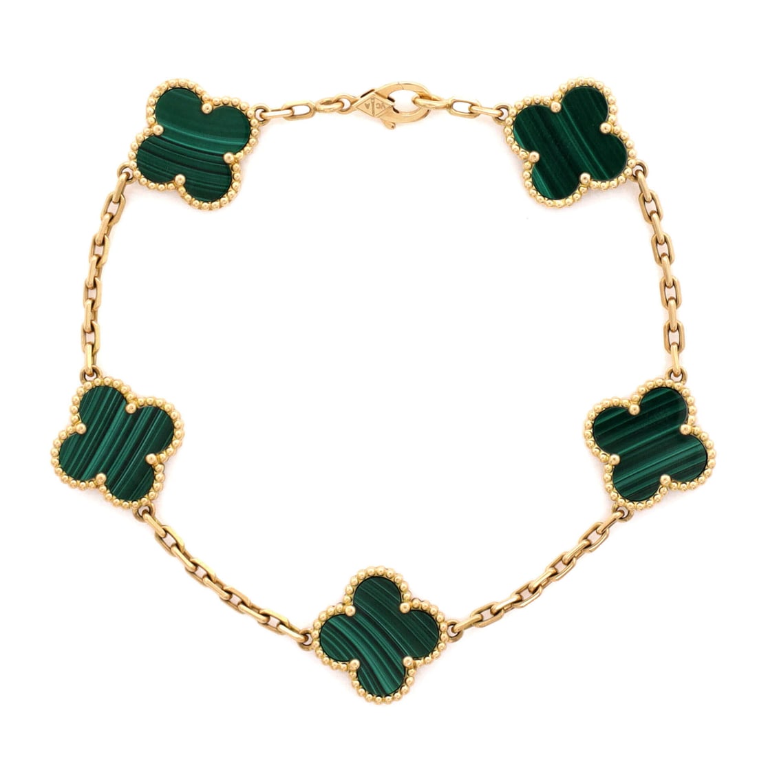 Van Cleef & Arpels Vintage Alhambra 5 Motifs Bracelet 18K Yellow Gold and Malachite: Wrought in yellow gold, the Van Cleef & Arpels Vintage Alhambra 5 Motifs Bracelet layers neatly under a sleeve and still reads from across the room. Worked in 18K Yellow Gold and Malachite. Its band p
