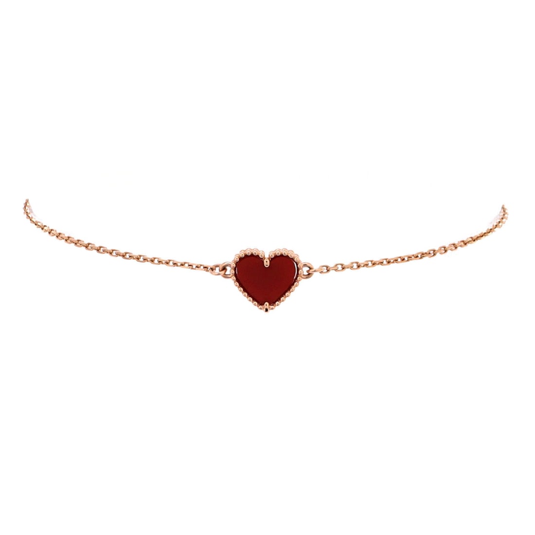 Van Cleef & Arpels Sweet Alhambra Heart Bracelet 18K Rose Gold with Carnelian: Stack-ready, the Van Cleef & Arpels Sweet Alhambra Heart Bracelet sits as low-profile as it does deliberate. Worked in 18K Rose Gold with Carnelian. The articulation traces the wrist closely, so it la