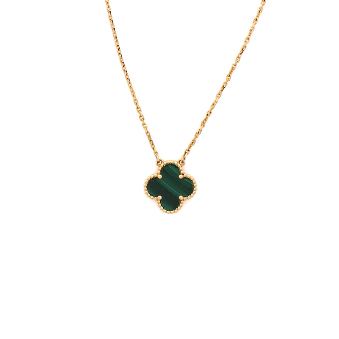 Van Cleef & Arpels Vintage Alhambra Pendant Necklace 18K Yellow Gold and Malachite: Layered to wear, the Van Cleef & Arpels Vintage Alhambra Pendant Necklace keeps its silhouette spare and its presence assured. Worked in 18K Yellow Gold and Malachite. Its proportions slip cleanly und