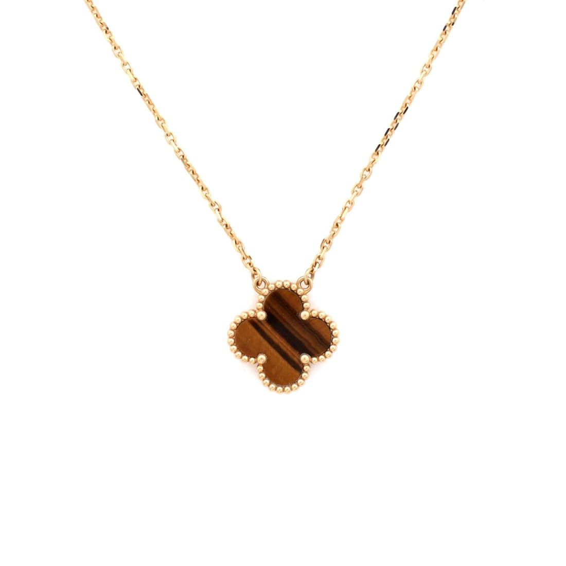 Van Cleef & Arpels Vintage Alhambra Pendant Necklace 18K Yellow Gold and Tiger Eye: Polished cleanly, the Van Cleef & Arpels Vintage Alhambra Pendant Necklace pulls focus to the collarbone with composed restraint. Worked in 18K Yellow Gold and Tiger Eye. Scale-wise it lives in the sw
