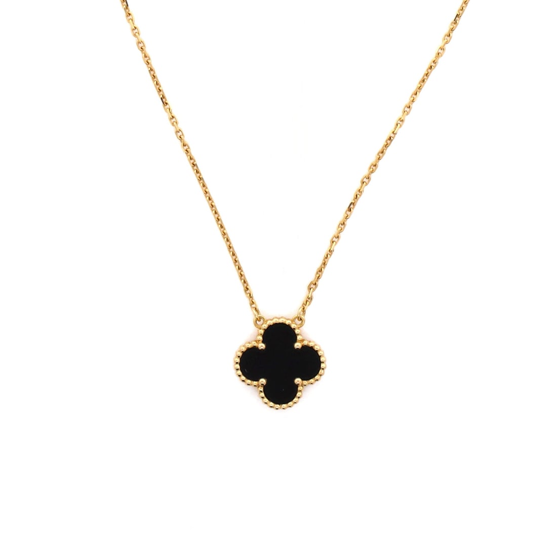 Van Cleef & Arpels Vintage Alhambra Pendant Necklace 18K Yellow Gold and Onyx: Crisply drawn, the Van Cleef & Arpels Vintage Alhambra Pendant Necklace pulls focus to the collarbone with composed restraint. Worked in 18K Yellow Gold and Onyx. Scale-wise it lives in the sweet spot