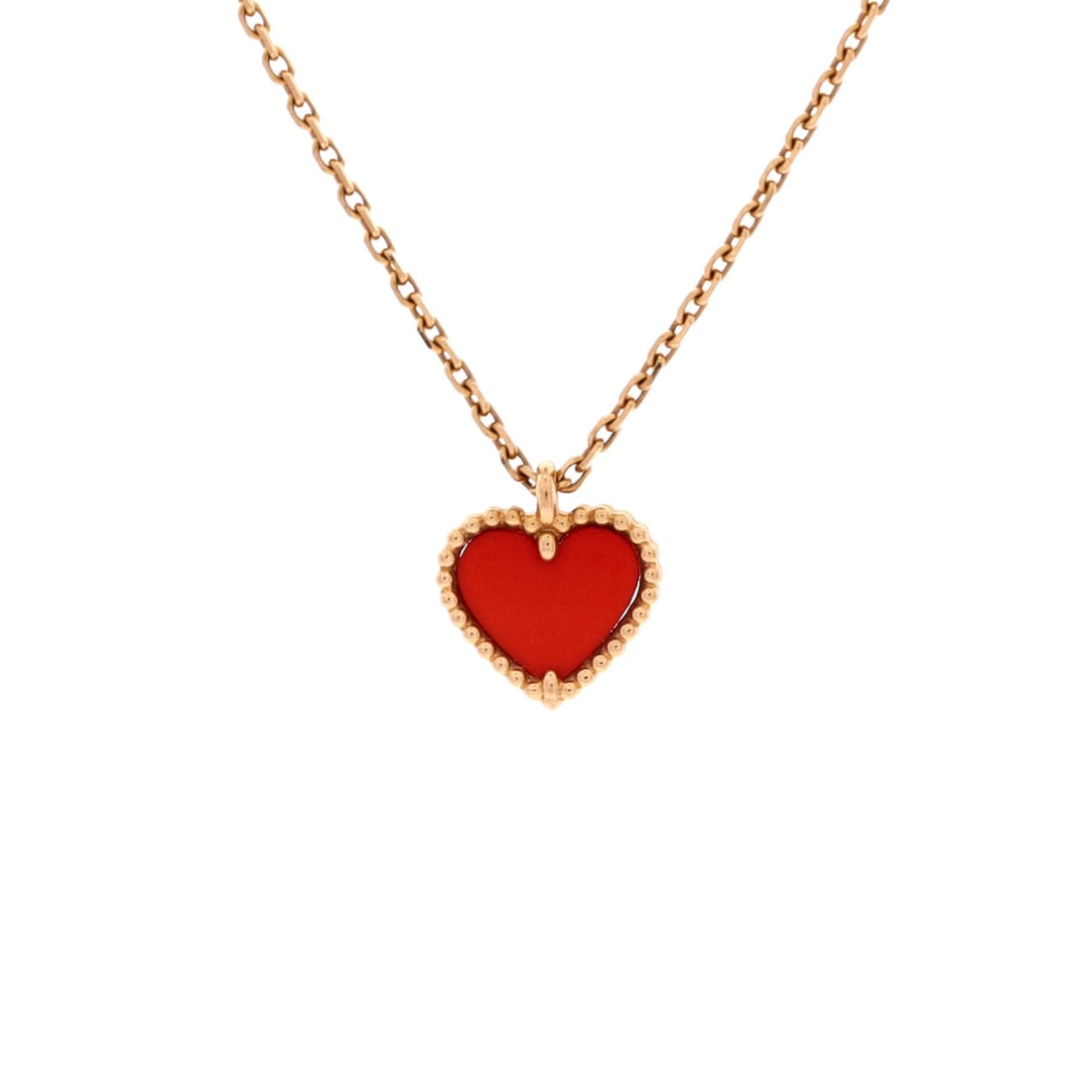Van Cleef & Arpels Sweet Alhambra Heart Pendant Necklace 18K Rose Gold and Carnelian: Worked in rose gold, the Van Cleef & Arpels Sweet Alhambra Heart Pendant Necklace threads its motif from clasp to charm with a single fluent gesture. Worked in 18K Rose Gold and Carnelian. Its proport