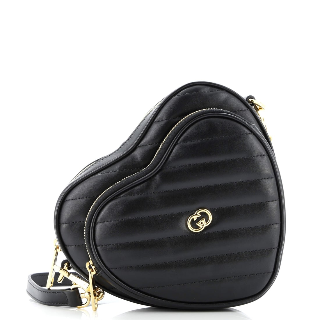 Gucci Interlocking G Heart Shoulder Bag Diagonal Quilted Leather Mini: The Gucci Interlocking G Heart Shoulder Bag rides where it should, an ergonomic geometry that explains why the silhouette has stayed in production. The black colorway sits richly across the surface,