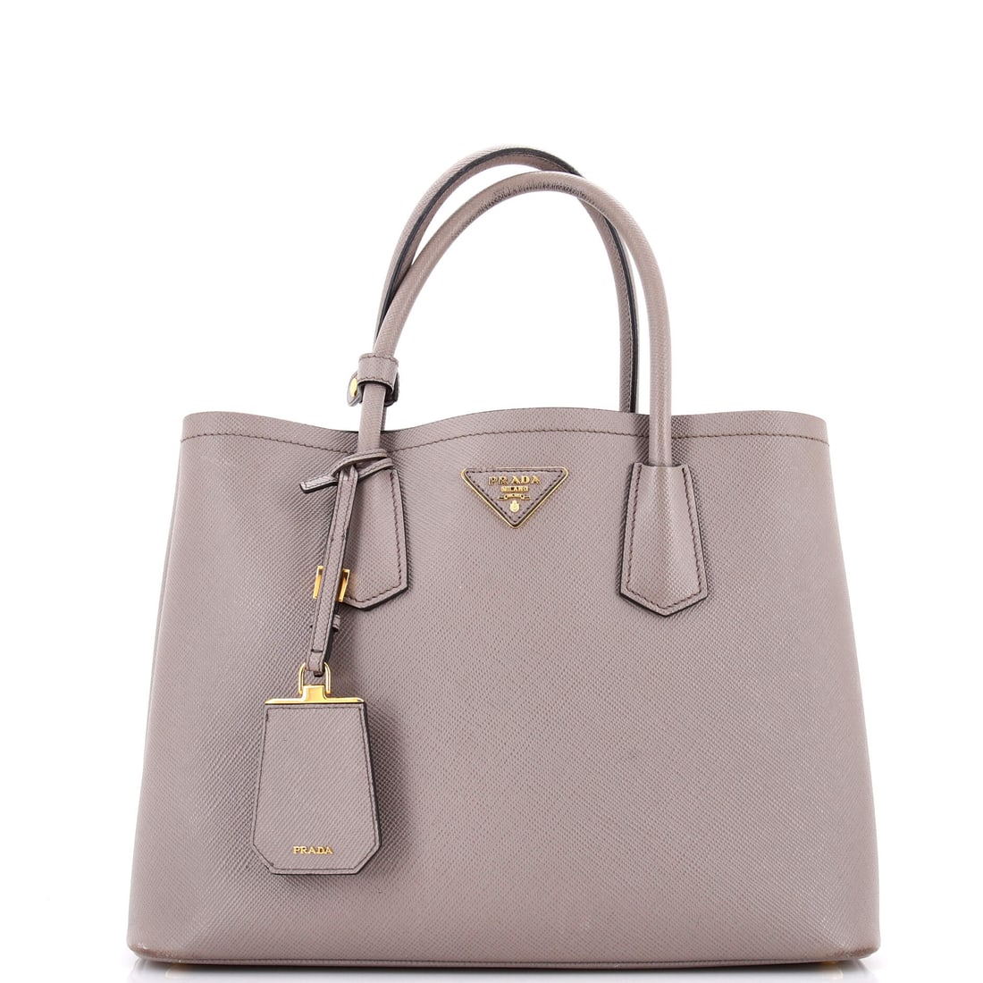 Prada Cuir Double Tote Saffiano Leather Medium: Worn, this Prada Cuir Double Tote reads light despite its presence, the kind of carry refinement that defines a working house bag. In gray, the silhouette reads modern without effort, rendered in