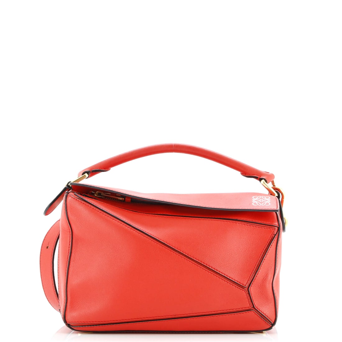 Loewe Puzzle Bag Leather Small: From the side, the Loewe Puzzle Bag reads as architecture first, a silhouette that has been refined into a settled idiom. A luminous red palette carries the read, holding the surface luminous against