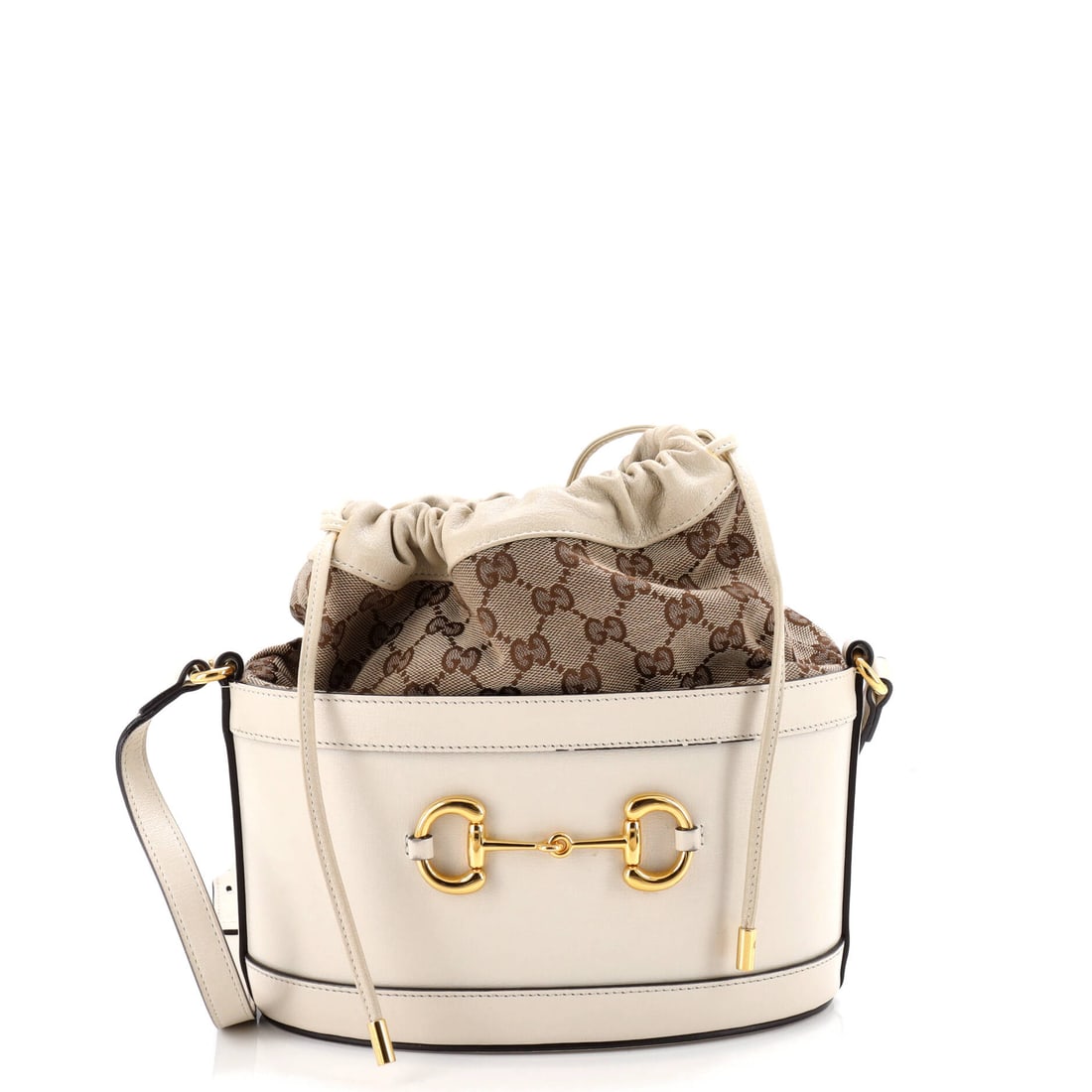 Gucci Horsebit 1955 Bucket Crossbody Bag Leather and GG Canvas Small: Cut from leather and gg canvas, the Gucci Horsebit 1955 Bucket Crossbody Bag reads soft to the touch and disciplined on the body. Cast in a saturated white, calibrated to read editorial in any light. 