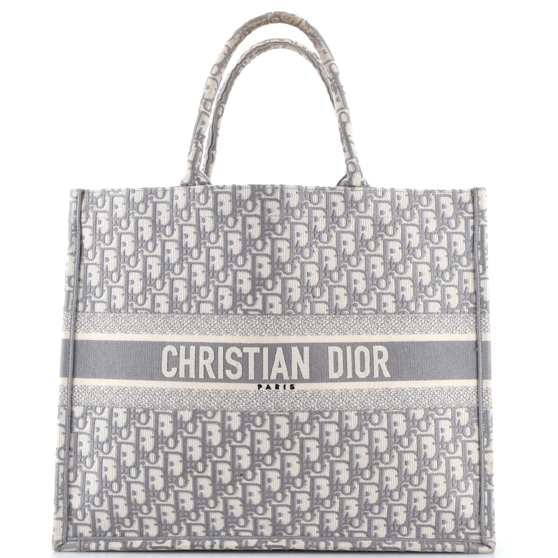 Christian Dior Book Tote Oblique Canvas Large: Drawn in oblique canvas, this Christian Dior Book Tote carries the surface character that only develops with the right atelier behind it. The gray treatment carries its own presence, calibrated to rea